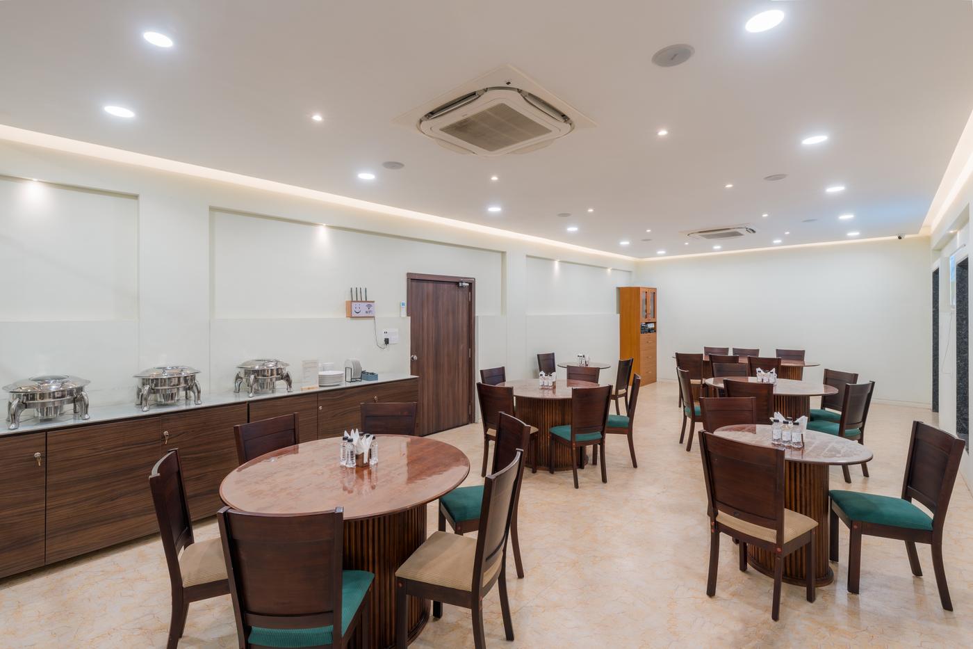 The guest dining room with round tables and a buffet counter